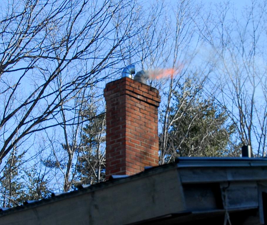 fire coming from the top of a chimney